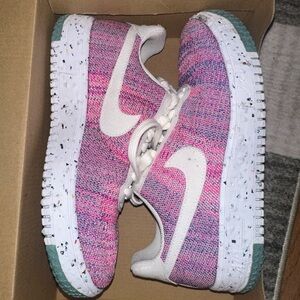 Pink and White Nike flynit